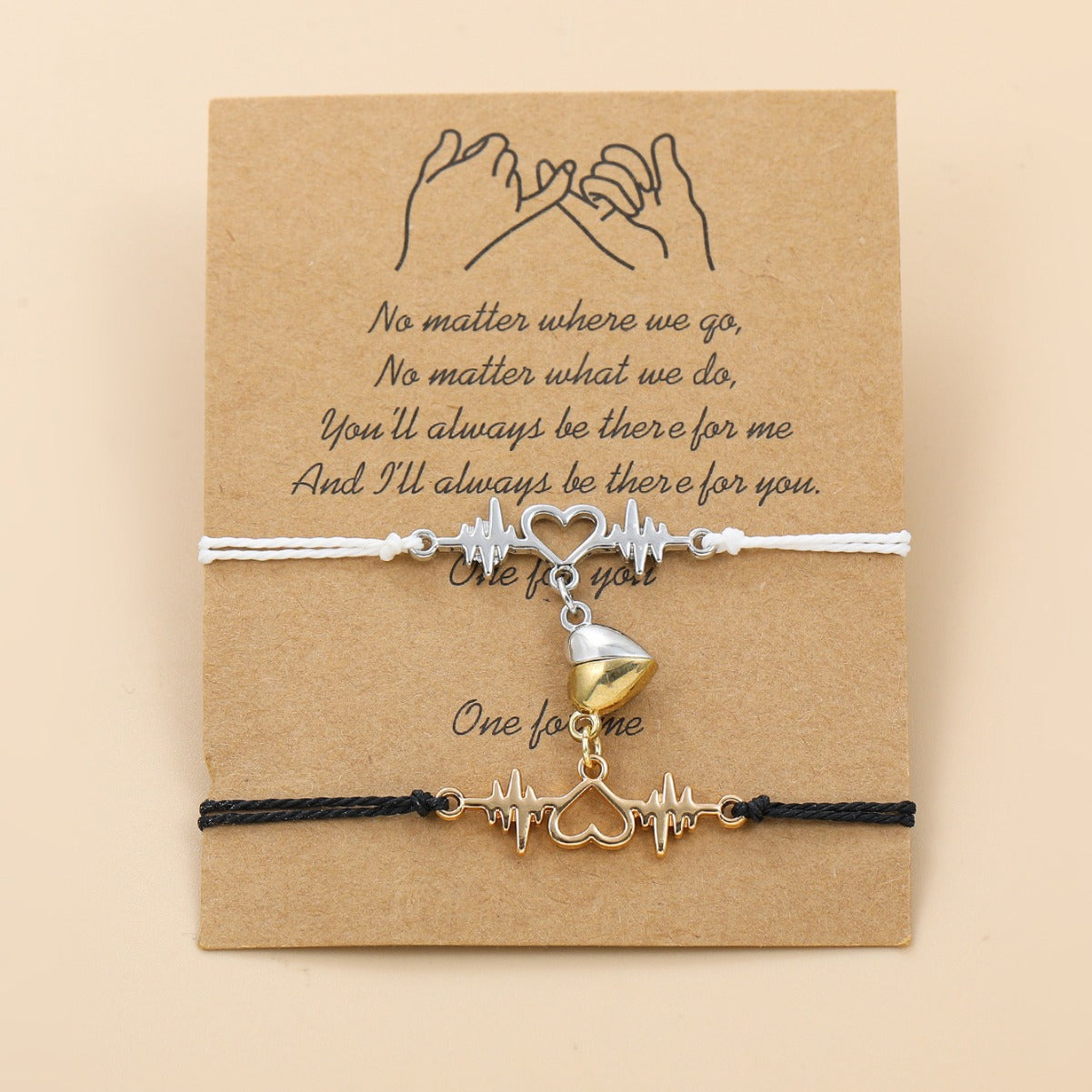 Two bracelets with heart and cupcake charms on a brown card with a quote.