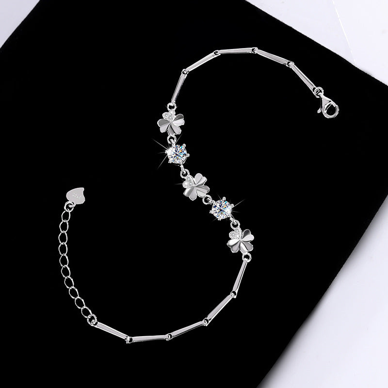 Silver bracelet with floral designs on a black background