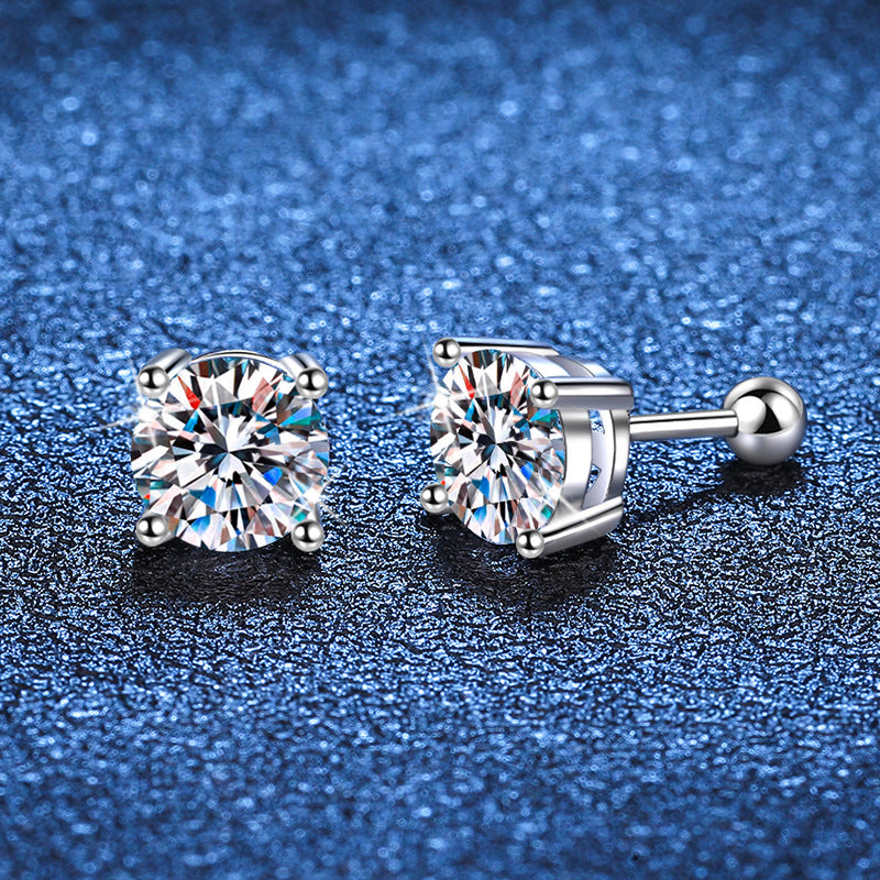 Pair of diamond stud earrings on a blue textured background