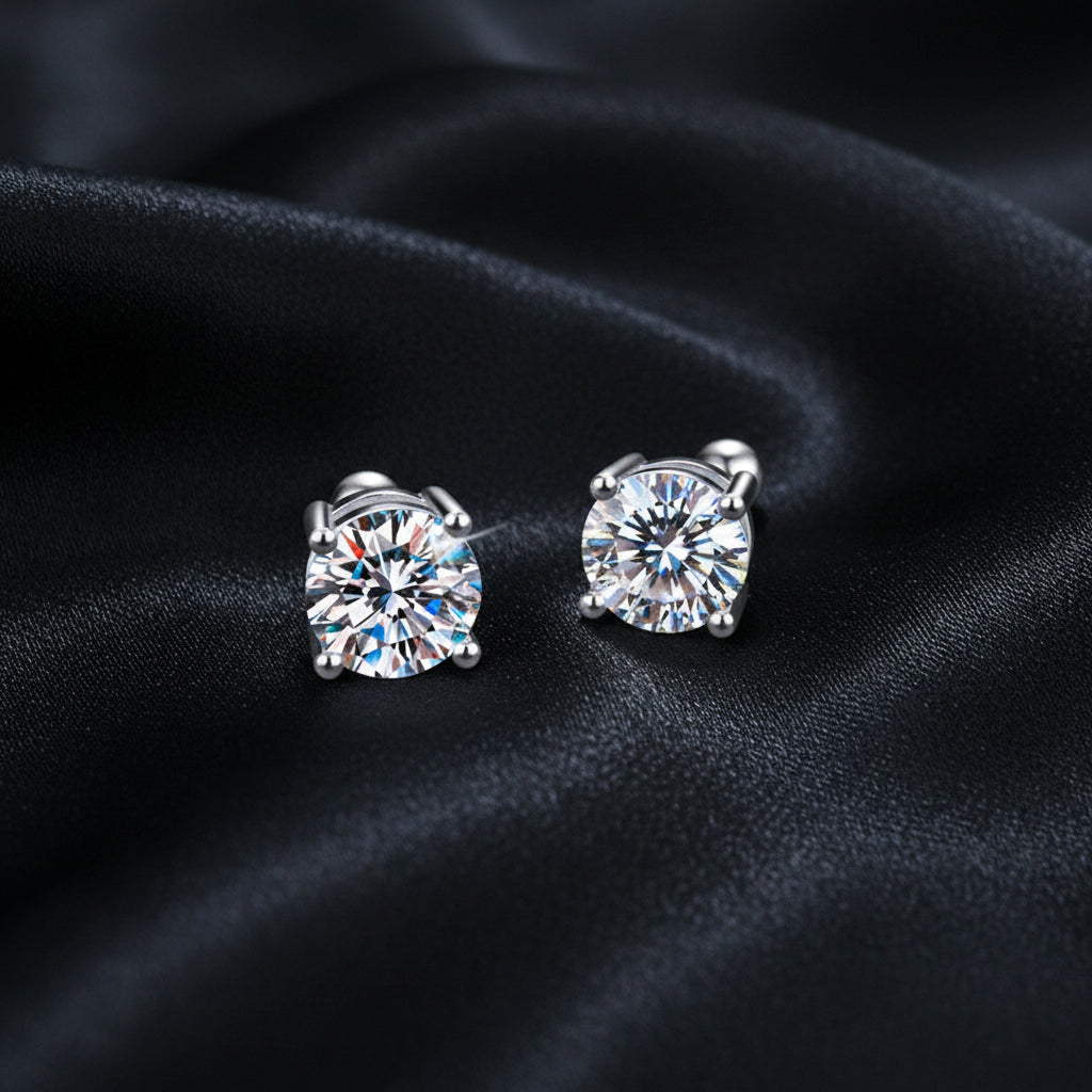Pair of silver stud earrings with clear gemstones on a white background image