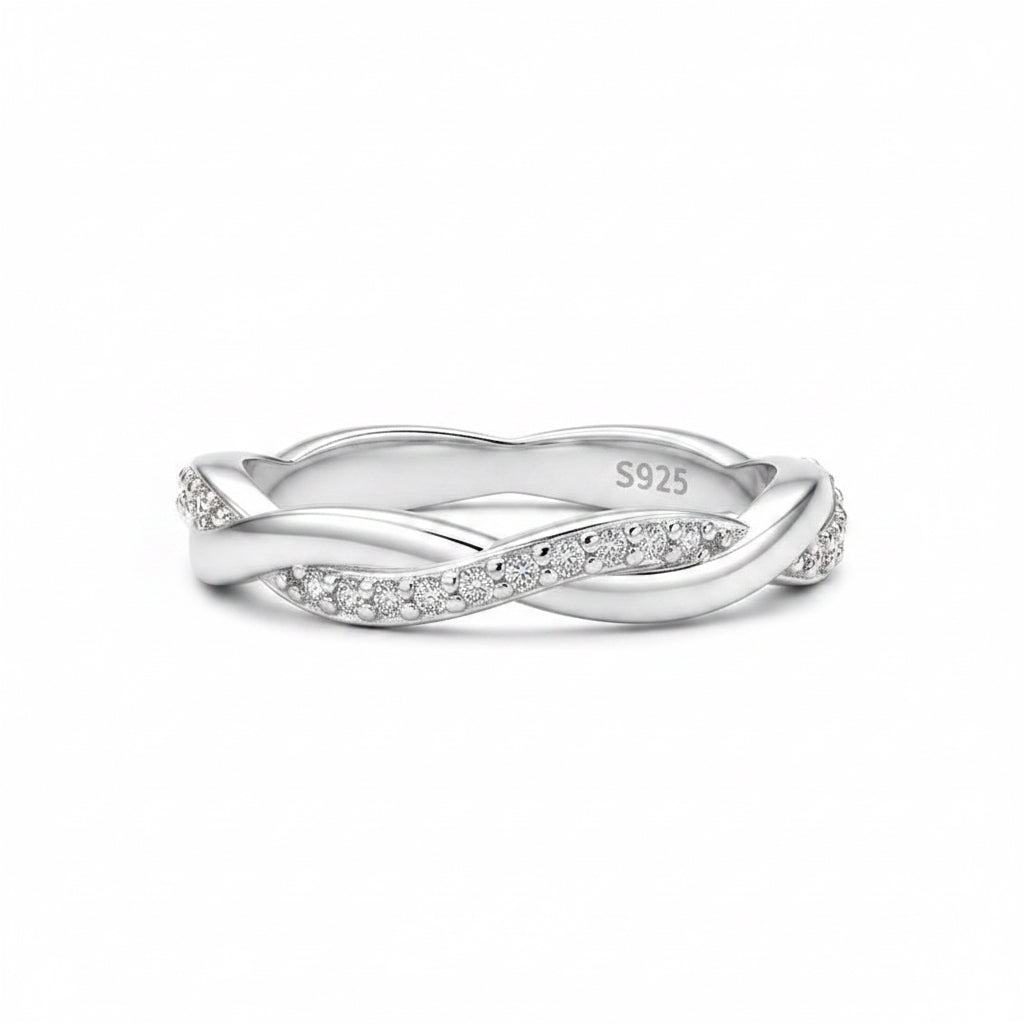 Silver ring with diamond accents on a white background