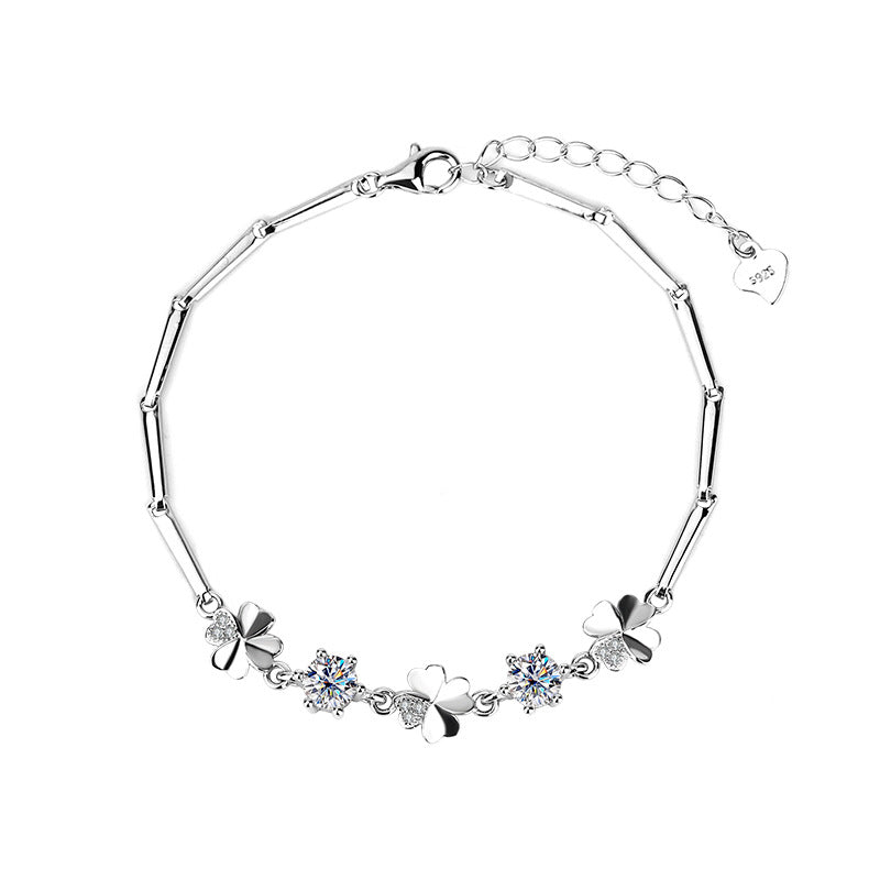 Silver bracelet with floral and butterfly designs on a white background