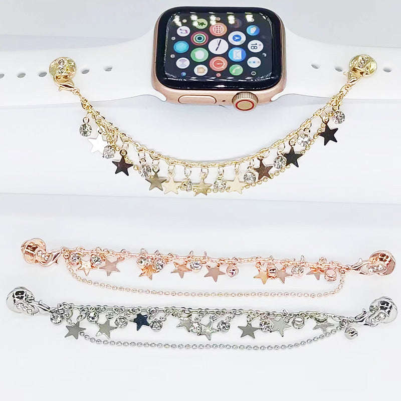 Gold, rose gold, and silver charm bracelets on a white surface with a smartwatch.